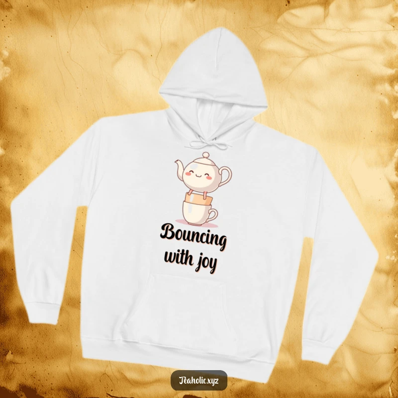 Funny, round, cheerful teapot character with legs, happily bouncing on a stack of mugs, featured on a cozy hoodie.