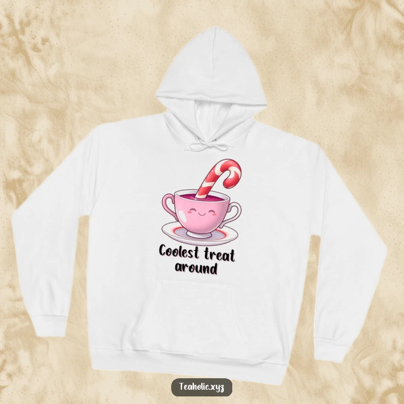 Funny candy cane with a cheerful smile dipping into a swirling teacup, featured on a warm and humorous hoodie.