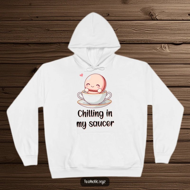 Funny blissful macaroon character floating on a tea saucer on a warm and comfortable hoodie.